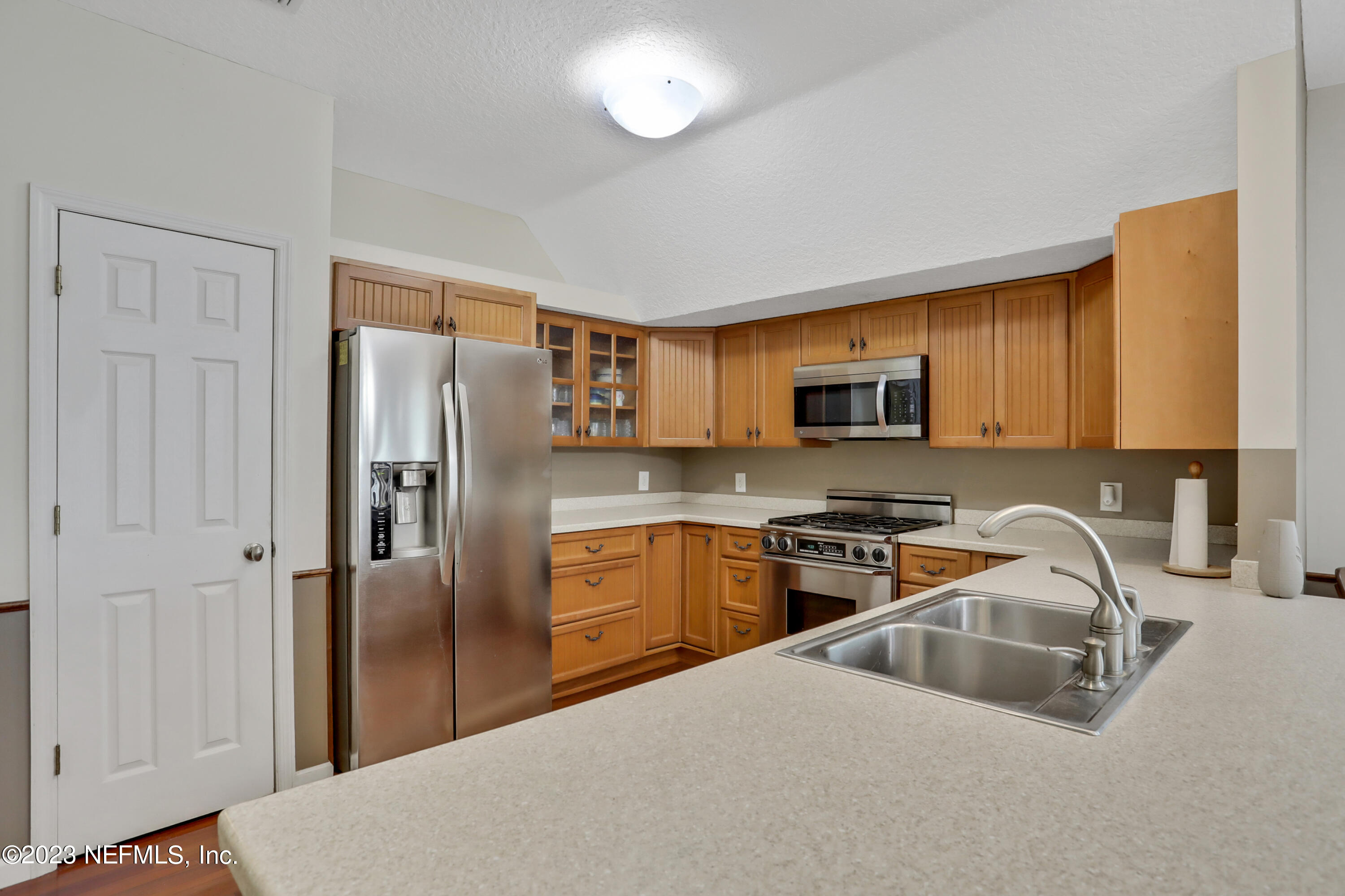 10100 Heckscher Drive Jacksonville, FL 32226 - Photo 35 of 90 a kitchen with stainless steel appliances granite countertop a refrigerator a stove top oven a sink and dishwasher