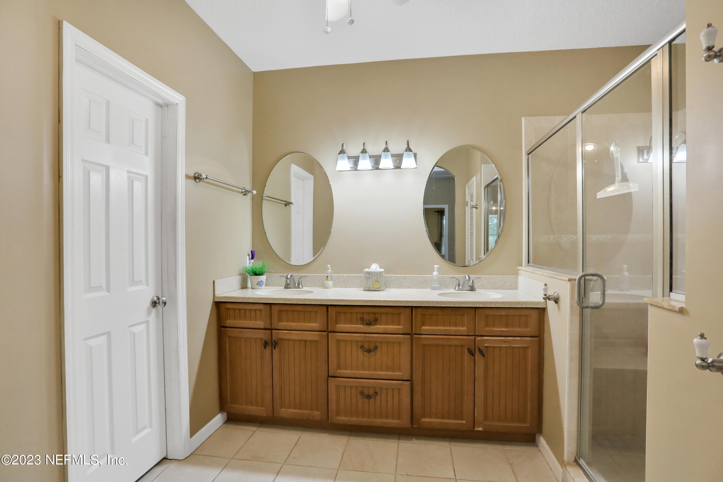 10100 Heckscher Drive Jacksonville, FL 32226 - Photo 43 of 90 a bathroom with a double vanity sink and a mirror