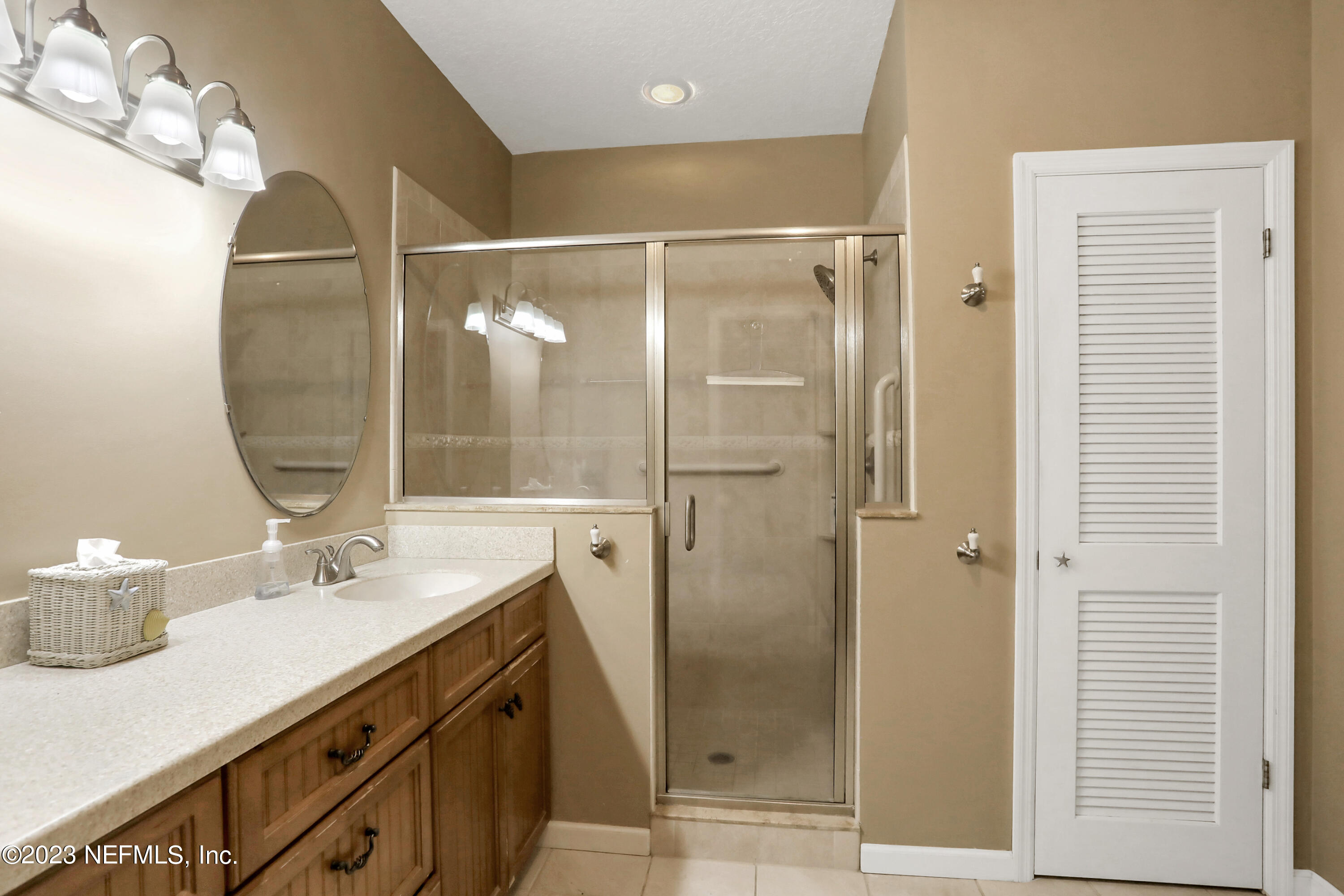 10100 Heckscher Drive Jacksonville, FL 32226 - Photo 44 of 90 a bathroom with a shower sink and mirror