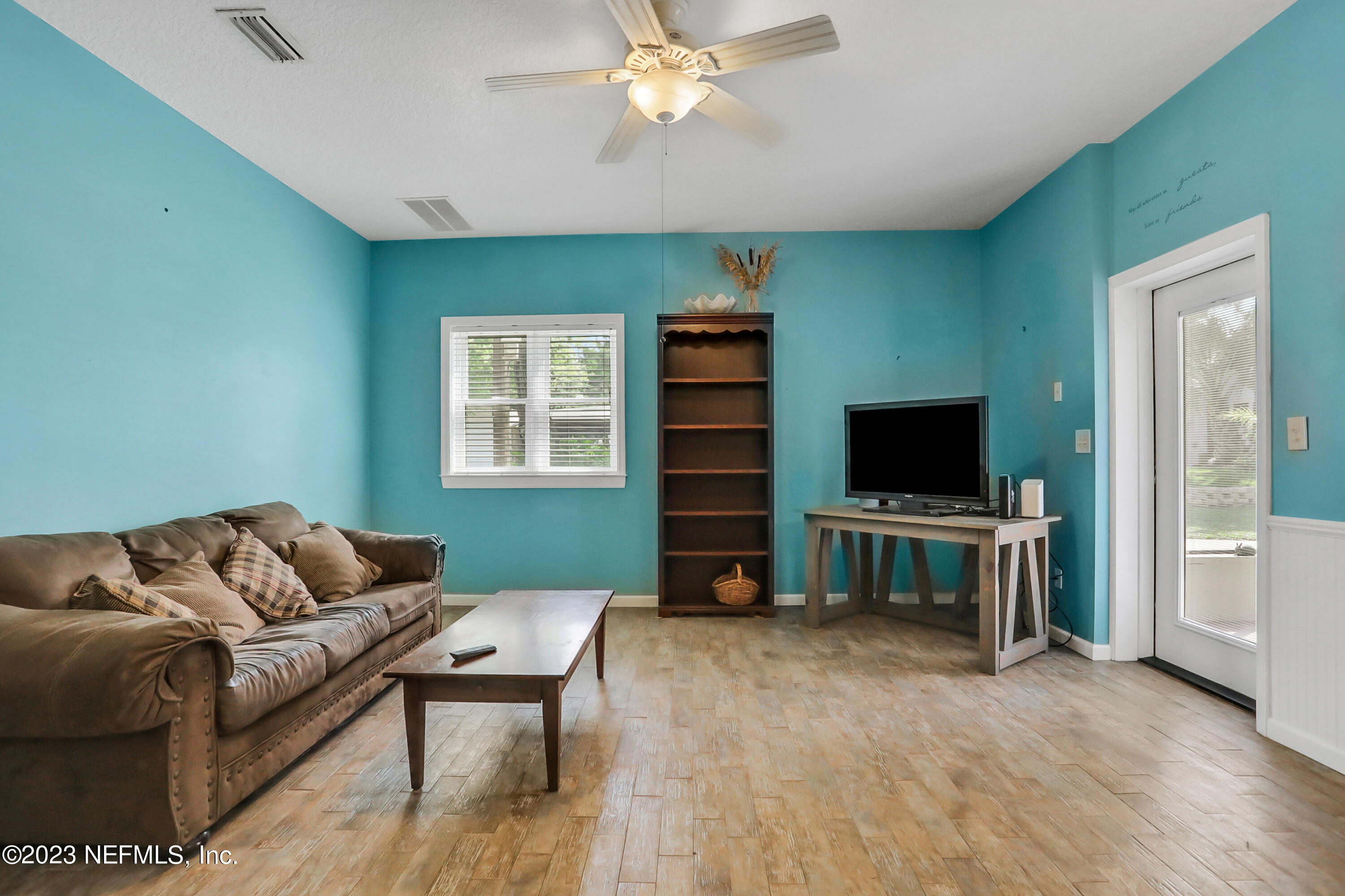 10100 Heckscher Drive Jacksonville, FL 32226 - Photo 62 of 90 a living room with furniture and a flat screen tv