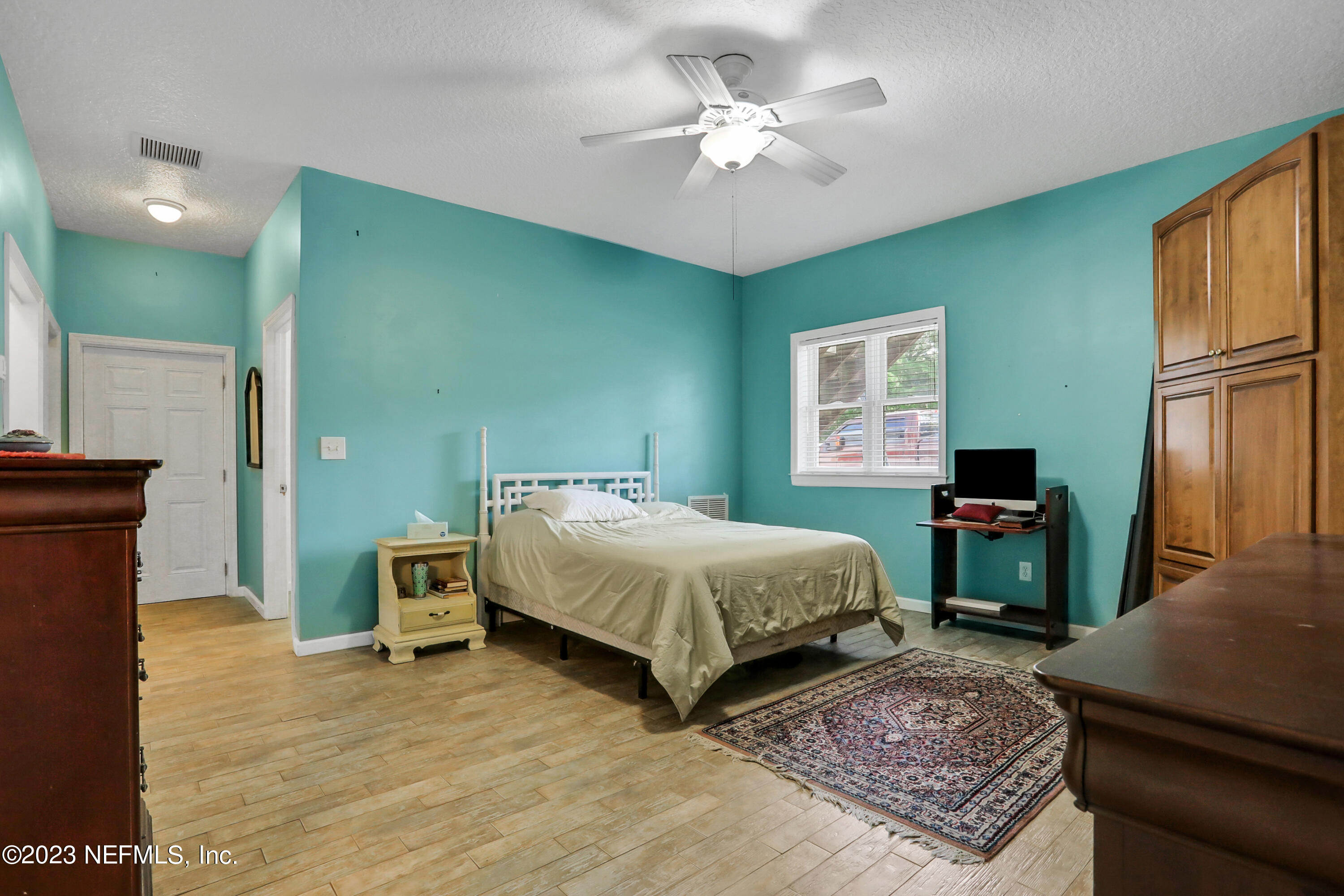10100 Heckscher Drive Jacksonville, FL 32226 - Photo 65 of 90 a spacious bedroom with a bed a dresser and a window