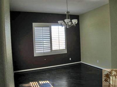 81908 Villa Reale Drive Indio, CA 92203 - Photo 3 of 25 a view of an empty room with wooden floor and a window