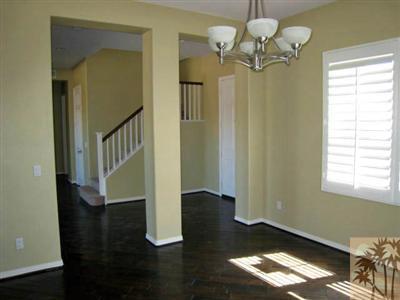 81908 Villa Reale Drive Indio, CA 92203 - Photo 4 of 25 a view of an entryway with wooden floor and a chandelier