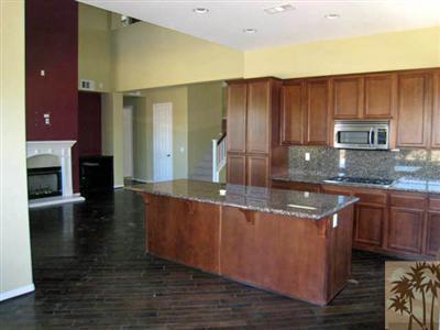 81908 Villa Reale Drive Indio, CA 92203 - Photo 7 of 25 a large kitchen with stainless steel appliances granite countertop a stove a sink and a microwave