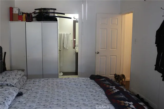 a bedroom with a bed and a mirror