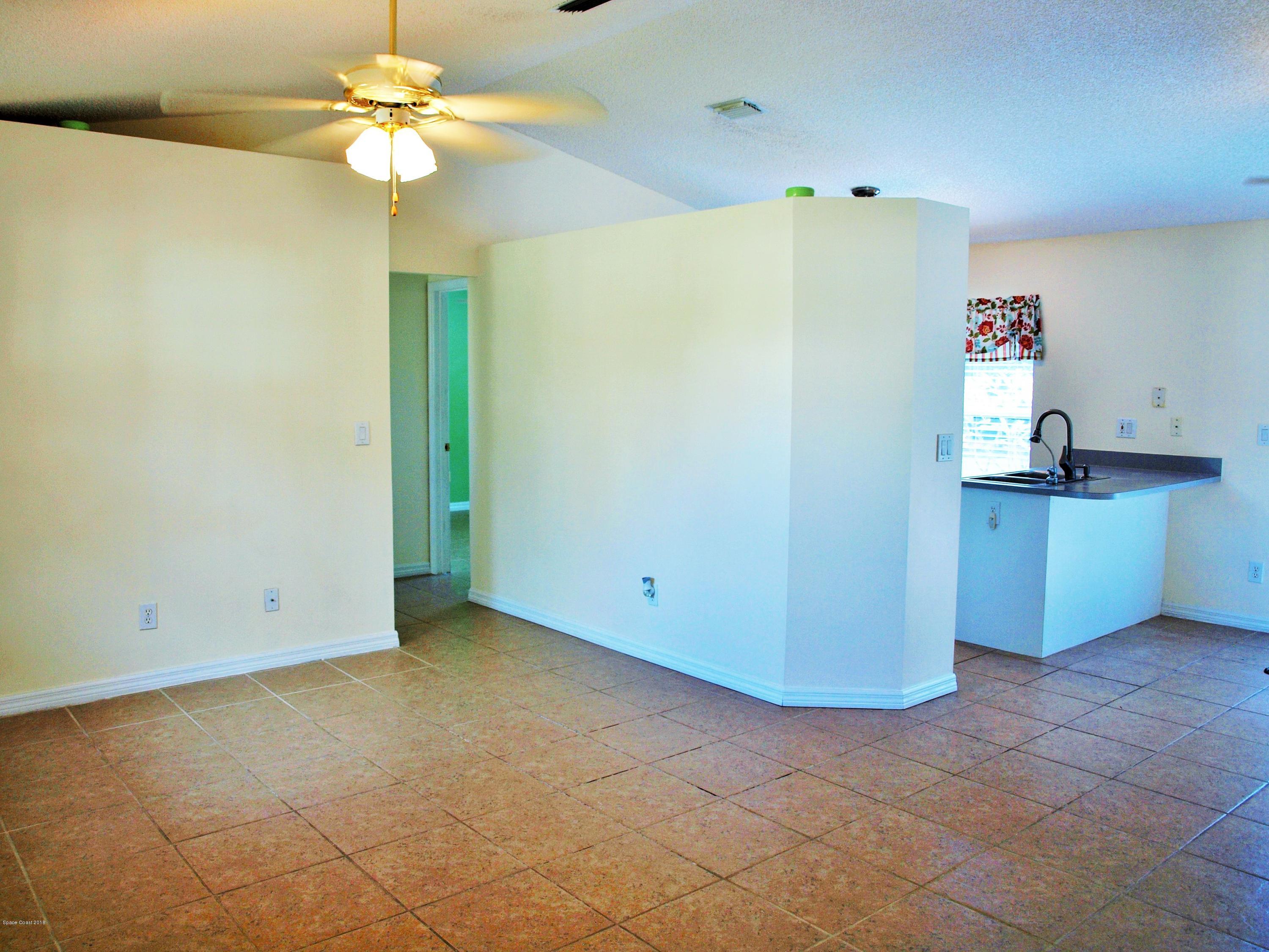 247 Crystal Lake Road Melbourne, FL 32901 - Photo 2 of 22 a view of a kitchen with a dishwasher and a microwave