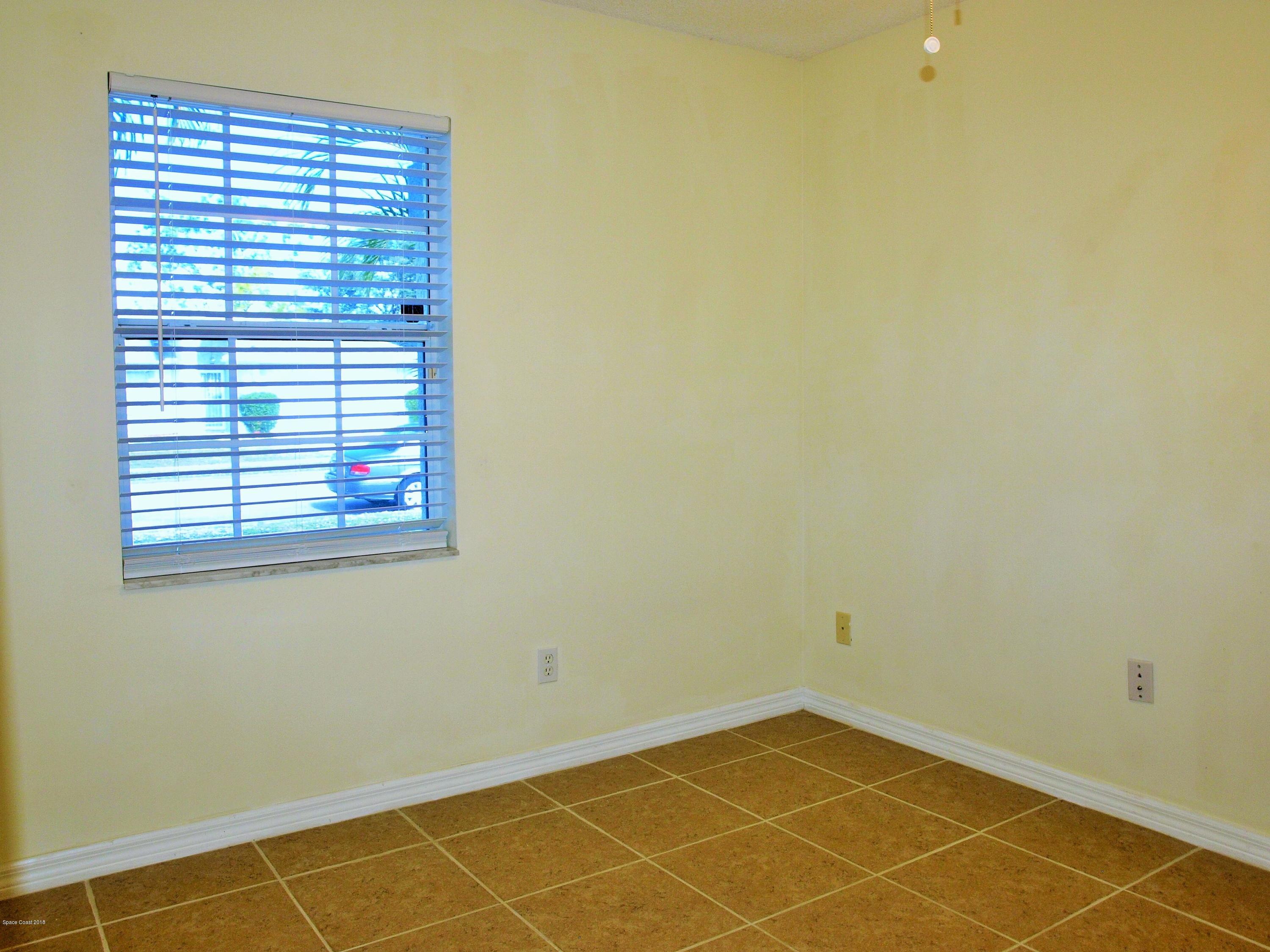 247 Crystal Lake Road Melbourne, FL 32901 - Photo 11 of 22 a view of an empty room with a window