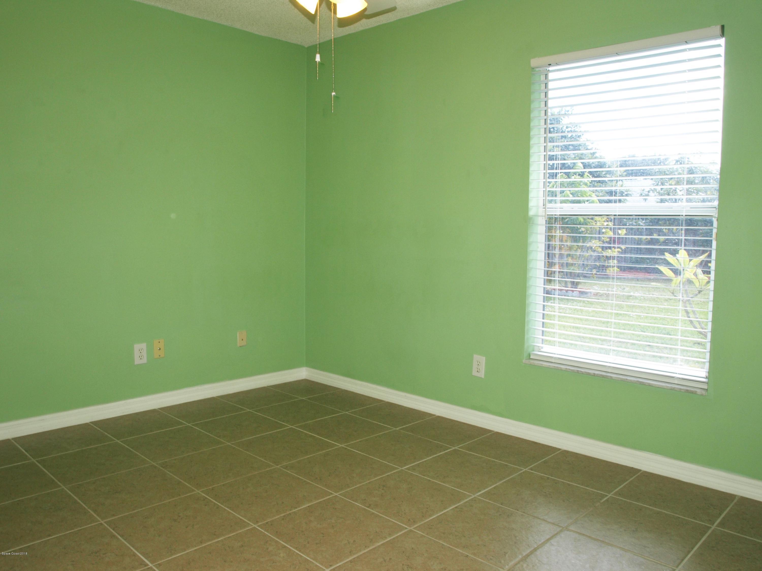 247 Crystal Lake Road Melbourne, FL 32901 - Photo 13 of 22 a view of a room that has a fan and a window