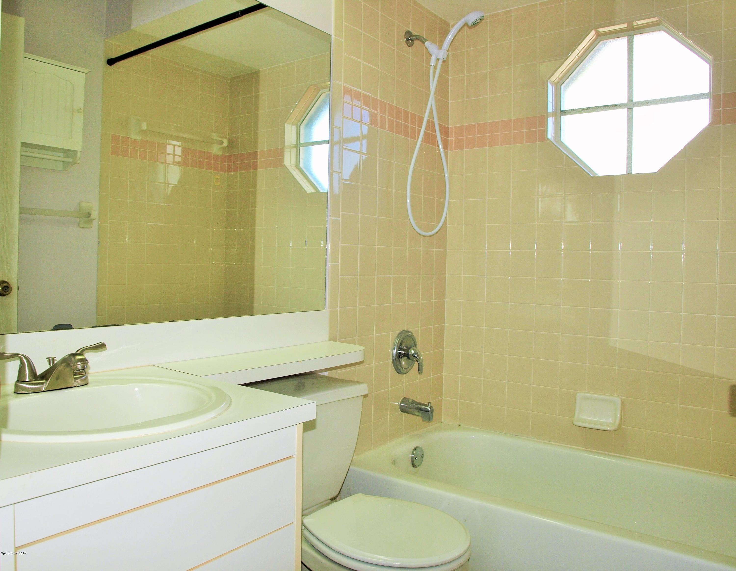 247 Crystal Lake Road Melbourne, FL 32901 - Photo 15 of 22 a bathroom with a sink toilet and shower