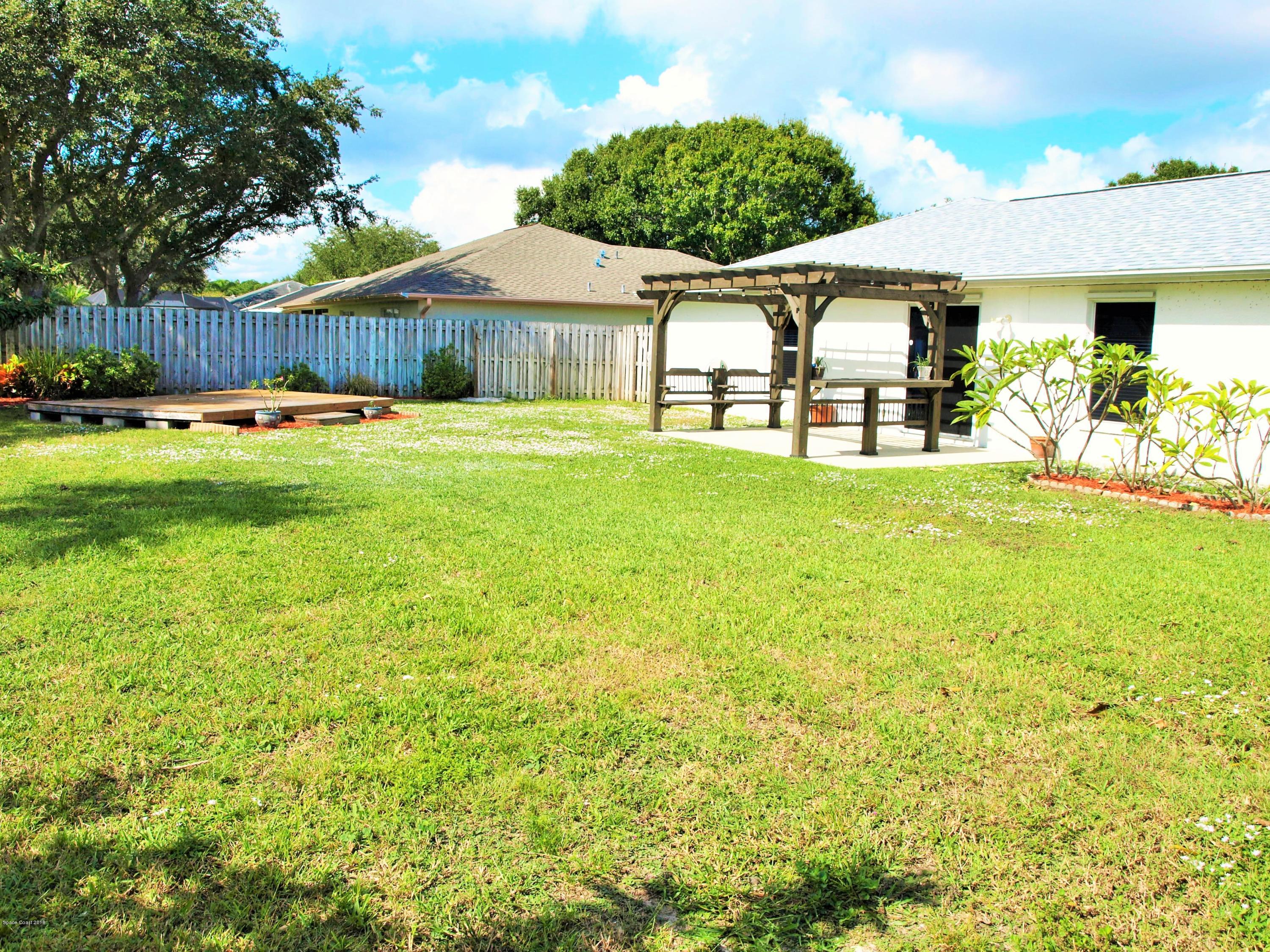 247 Crystal Lake Road Melbourne, FL 32901 - Photo 17 of 22 a front view of a house with a garden