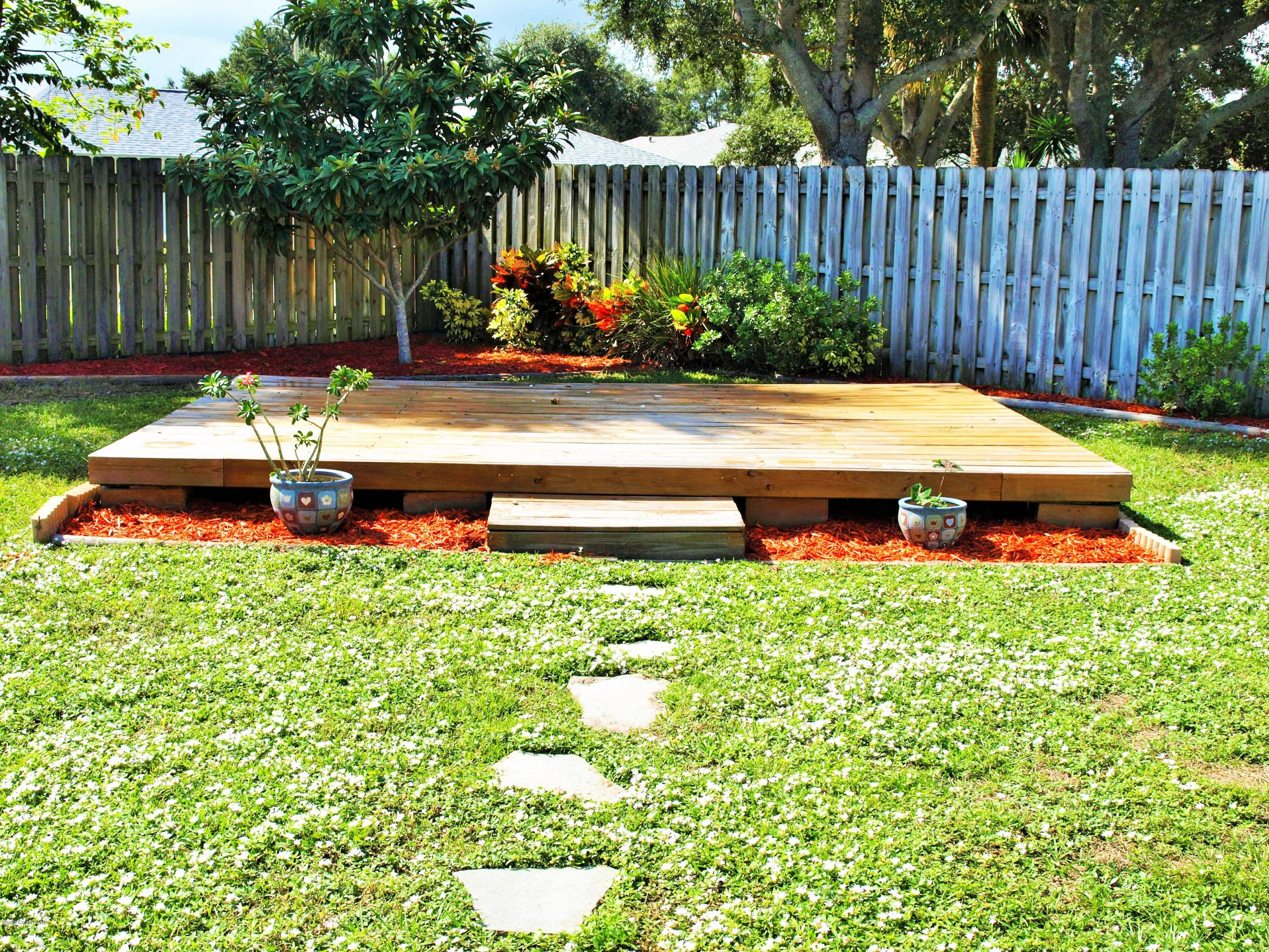 247 Crystal Lake Road Melbourne, FL 32901 - Photo 18 of 22 a view of a backyard with plants and tree