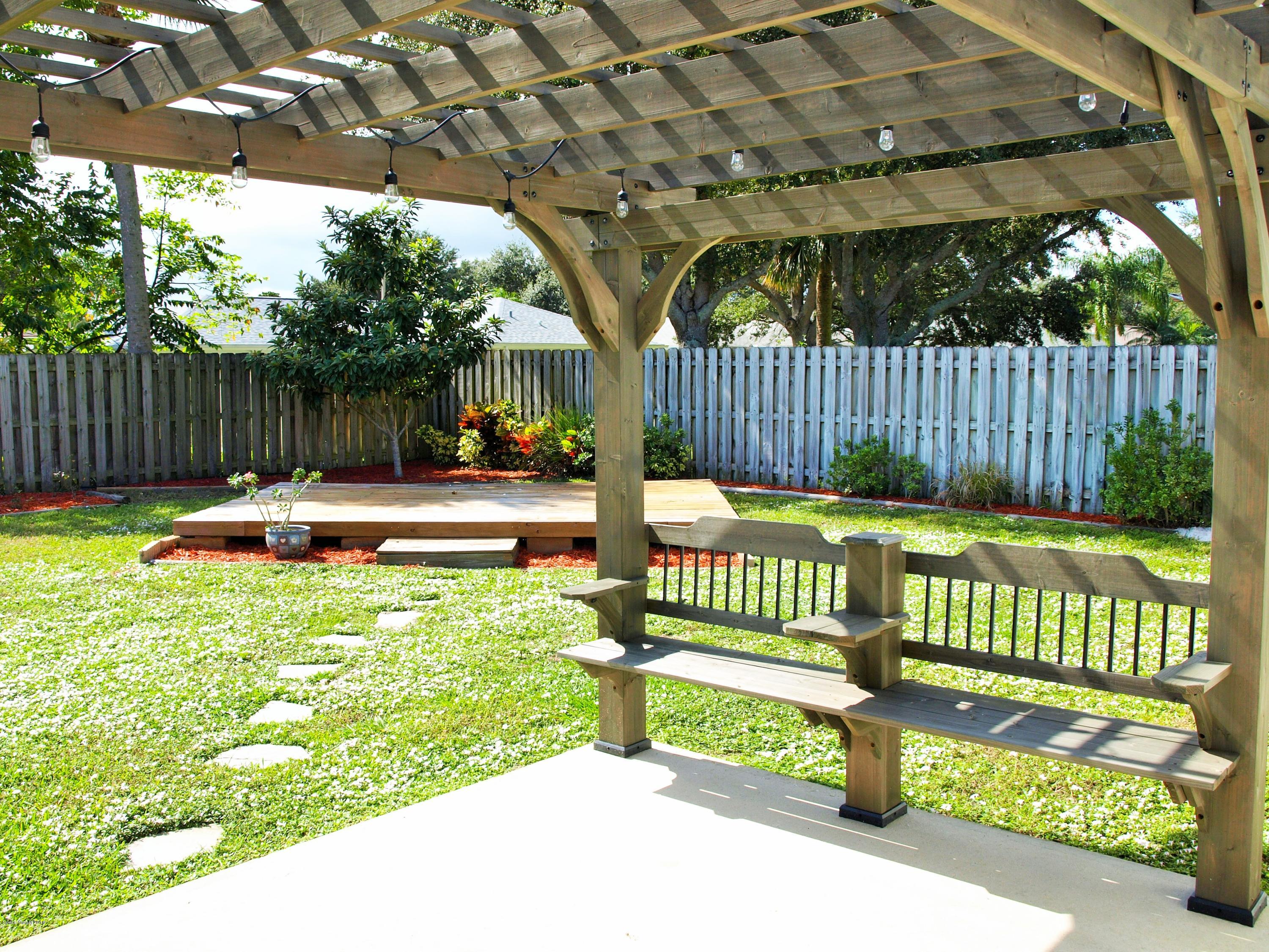 247 Crystal Lake Road Melbourne, FL 32901 - Photo 21 of 22 a garden view with a bench