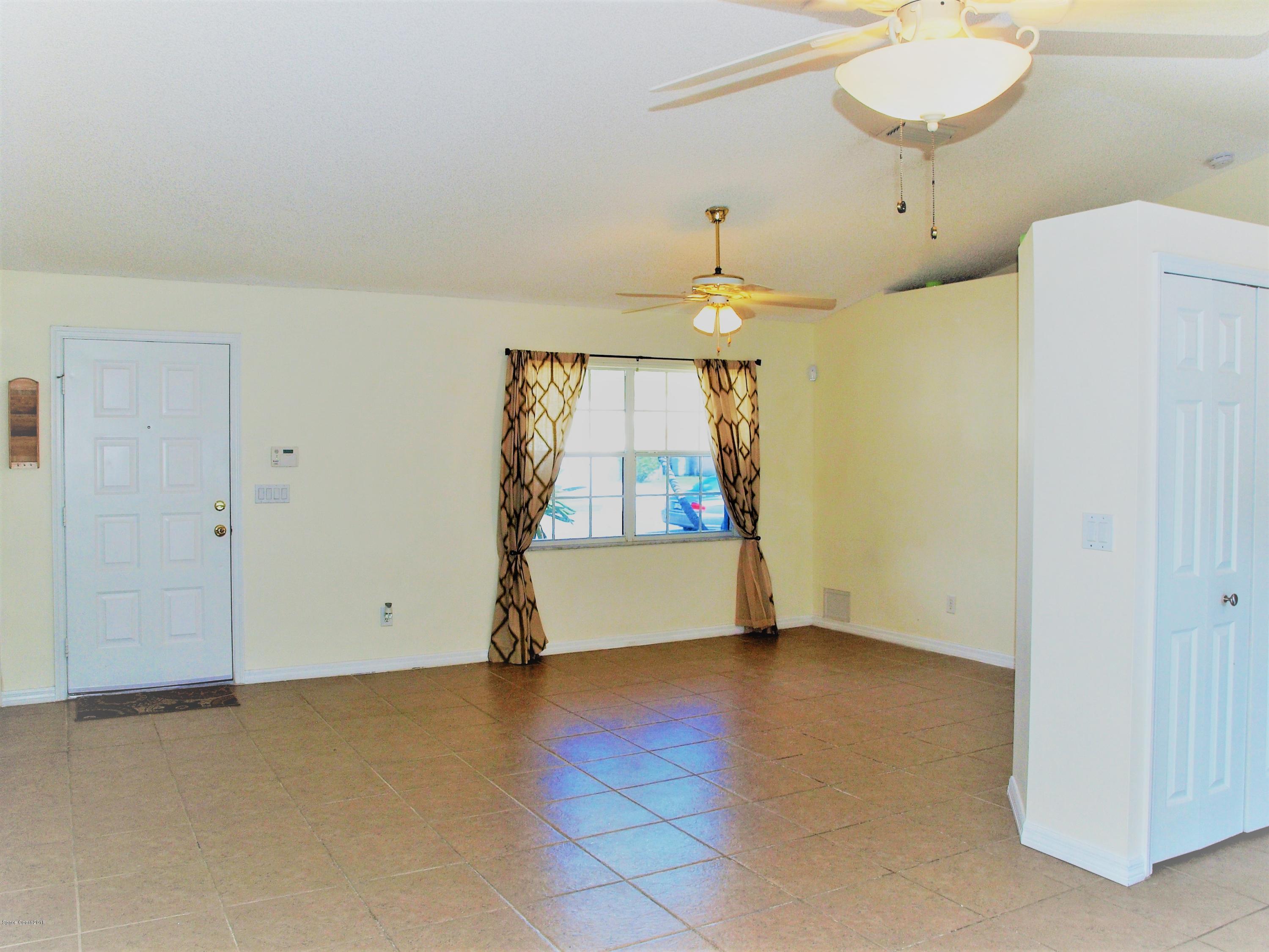 247 Crystal Lake Road Melbourne, FL 32901 - Photo 4 of 22 an empty room with a door