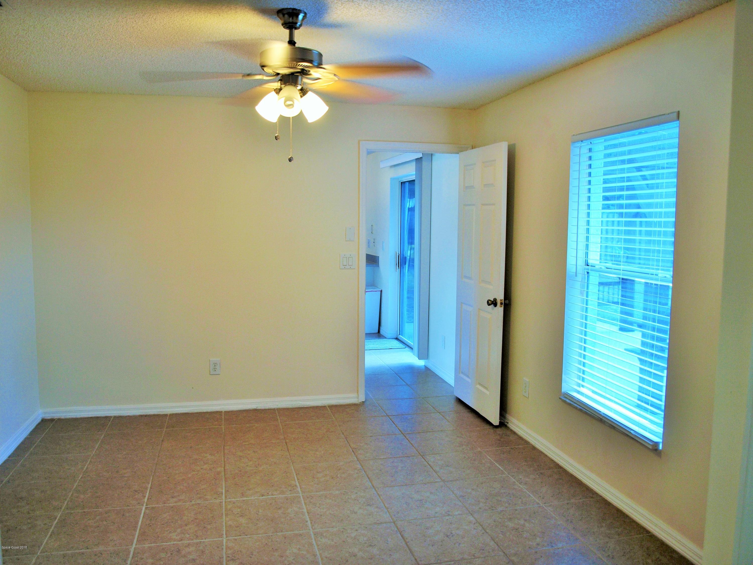 247 Crystal Lake Road Melbourne, FL 32901 - Photo 9 of 22 a view of a livingroom with a chandelier fan