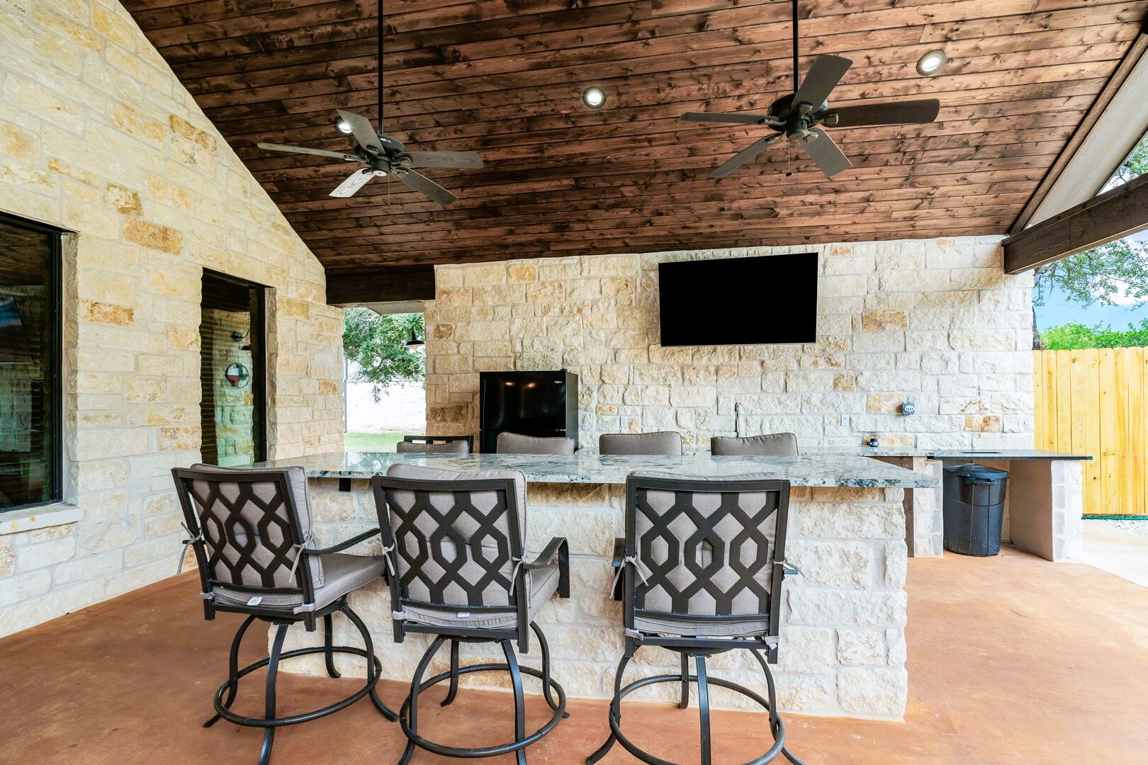 1718 Mountain Valley Road Concan, TX 78838 - Photo 29 of 40 Stone walls and a natural wood ceiling define this sheltered outdoor entertaining space.