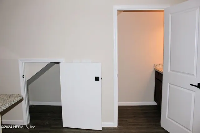 a view of small space with wooden floor and closet