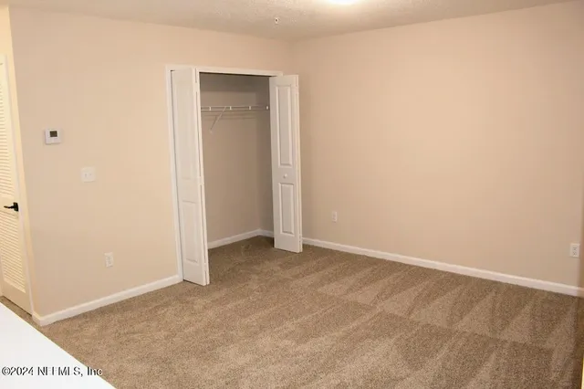 a view of hallway with bathroom