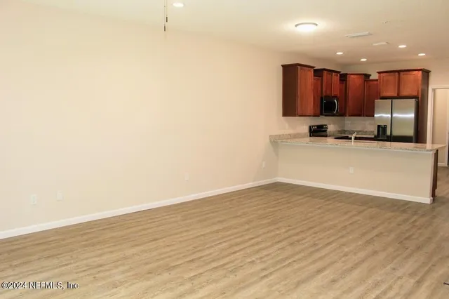 a view of kitchen with wooden floor