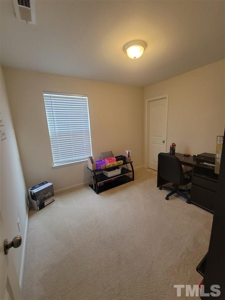 6343 Slopeside Court Raleigh, NC 27610 - Photo 4 of 14 a living room with furniture and a flat screen tv