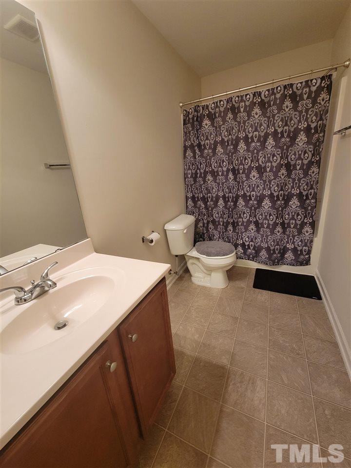 6343 Slopeside Court Raleigh, NC 27610 - Photo 5 of 14 a bathroom with a sink toilet and shower