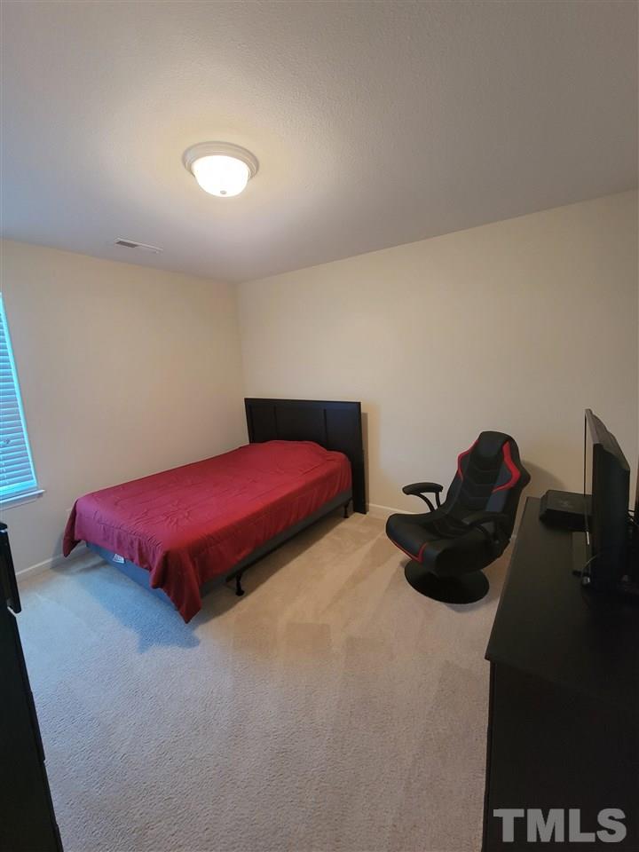6343 Slopeside Court Raleigh, NC 27610 - Photo 6 of 14 a bedroom with a bed and a closet