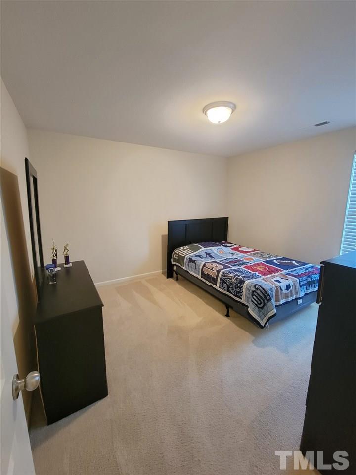 6343 Slopeside Court Raleigh, NC 27610 - Photo 7 of 14 a bedroom with bed and window
