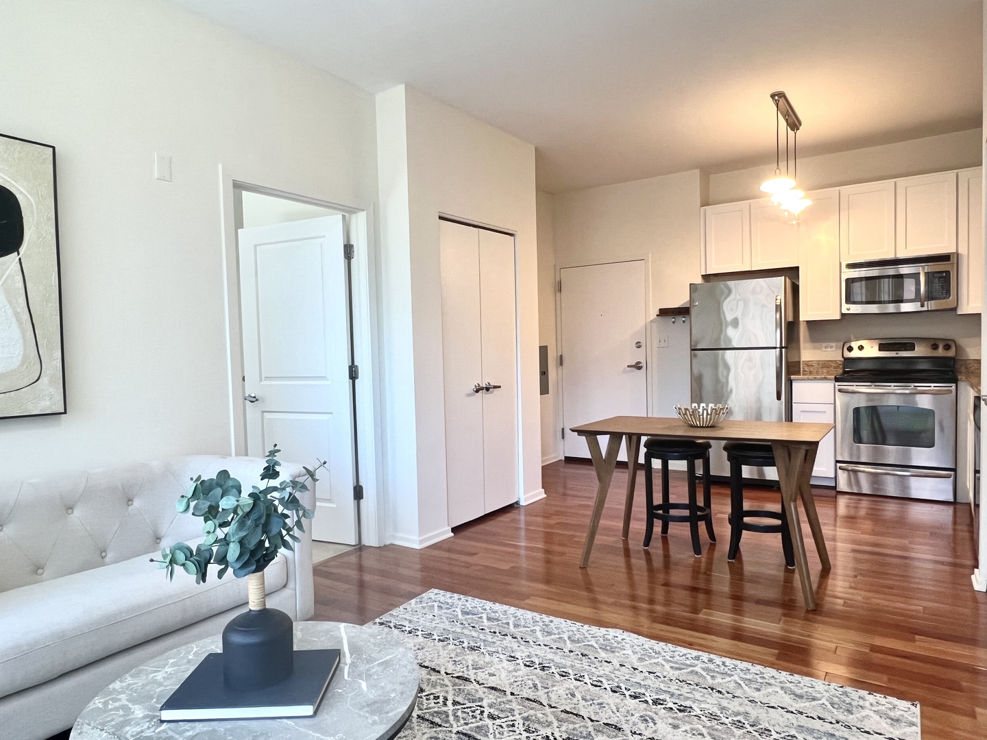 1 East 8th Street, Unit 307 Chicago, IL 60605 - Photo 12 of 24 a view of a dining room with furniture and wooden floor