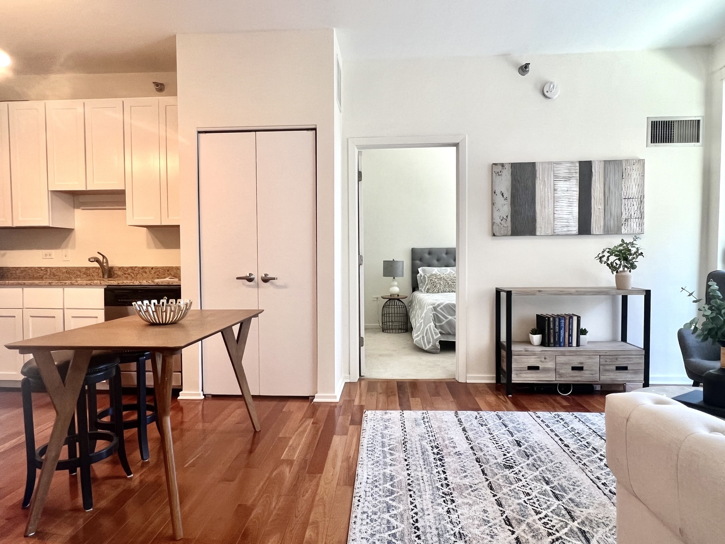 1 East 8th Street, Unit 307 Chicago, IL 60605 - Photo 17 of 24 a living room with furniture and wooden floor