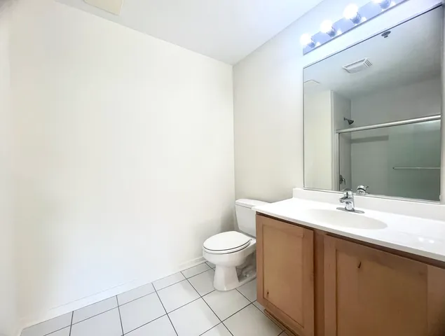 a bathroom with a sink a toilet a mirror and vanity