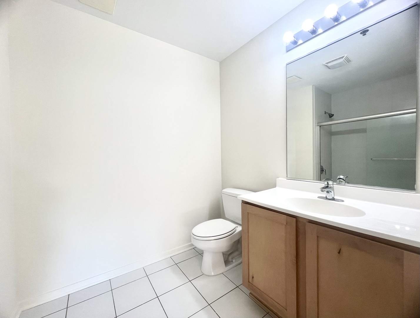 1 East 8th Street, Unit 307 Chicago, IL 60605 - Photo 19 of 23 a bathroom with a sink a toilet a mirror and vanity