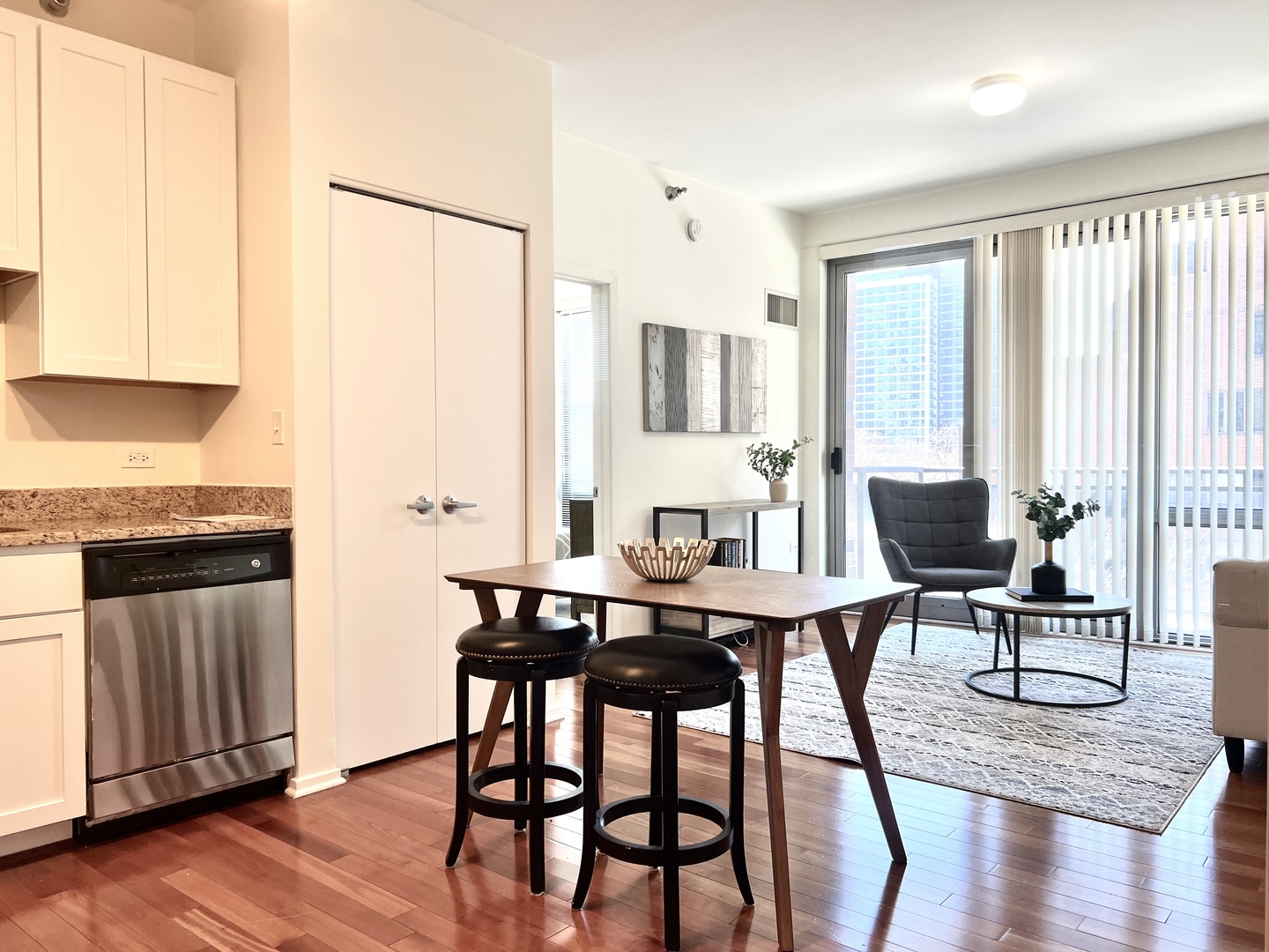 1 East 8th Street, Unit 307 Chicago, IL 60605 - Photo 2 of 24 a view of a dining room with furniture and wooden floor