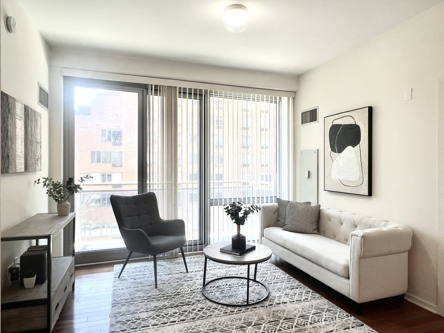 1 East 8th Street, Unit 307 Chicago, IL 60605 - Photo 5 of 24 a living room with furniture and a large window