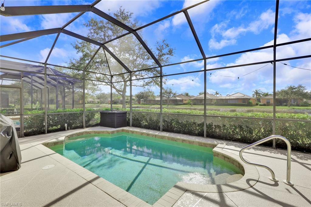 15464 Cortona Way Naples, FL 34120 - Photo 1 of 47 Swimming pool featuring glass enclosure, a sunroom, grilling area, a residential view, and a patio area