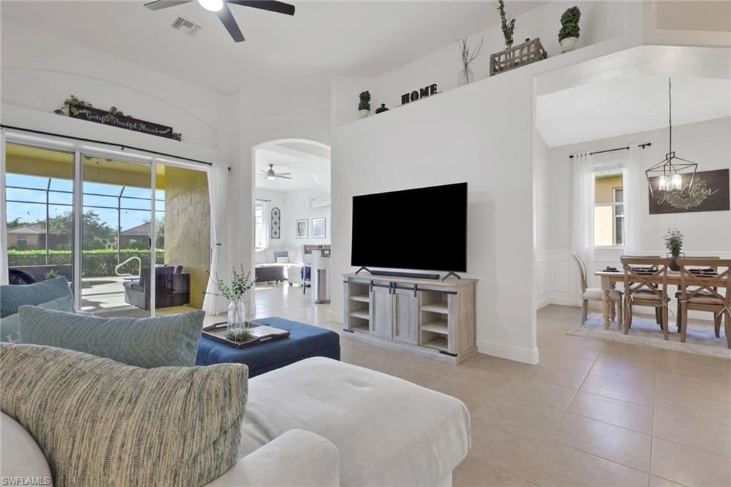 15464 Cortona Way Naples, FL 34120 - Photo 11 of 47 Living area with light tile patterned floors and a ceiling fan