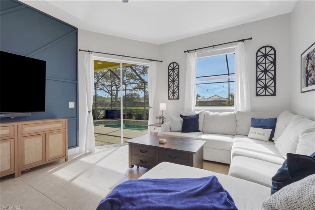 15464 Cortona Way Naples, FL 34120 - Photo 12 of 47 Living area featuring light tile patterned floors and a sunroom