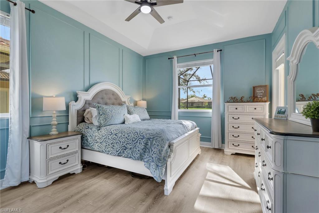 15464 Cortona Way Naples, FL 34120 - Photo 16 of 47 a bedroom with a bed and a dresser