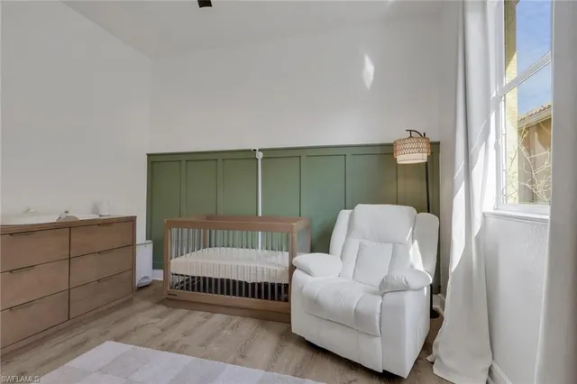 a bedroom with a white bed and white cabinets