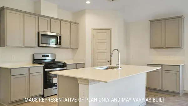 a kitchen with stainless steel appliances a stove a sink a microwave and cabinets