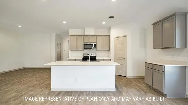 a kitchen with kitchen island a sink a stove a refrigerator and a oven