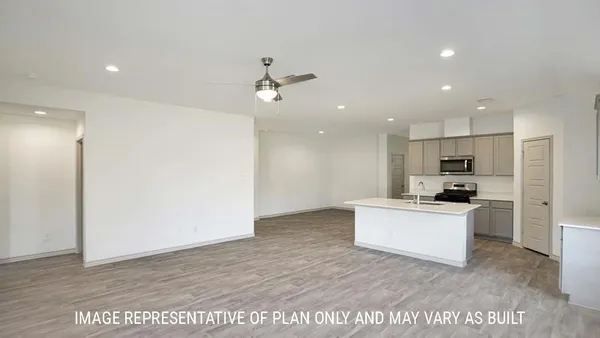 a kitchen with a refrigerator and a stove top oven