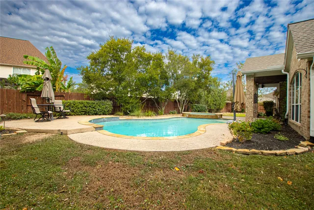 a view of a swimming pool with a yard