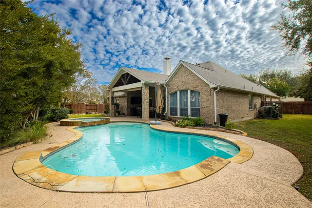 a view of a house with swimming pool and a yard