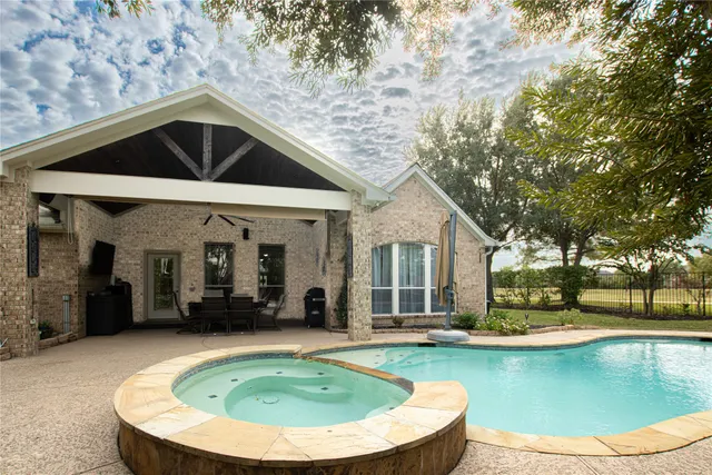 a view of a house with swimming pool and porch