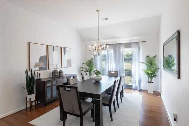 a view of a dining room with furniture and window