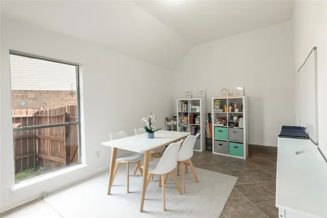 a large bedroom with bed couches and flat tv screen