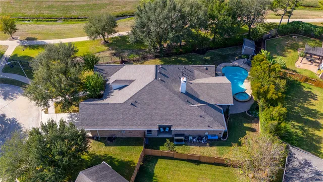 an aerial view of house with yard swimming pool and outdoor seating