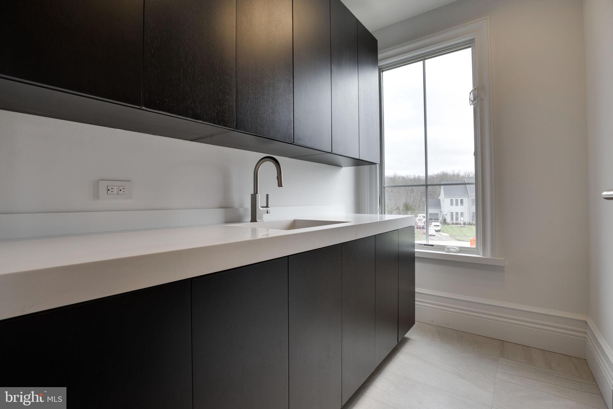 23075 Red Sunset Place Aldie, VA 20105 - Photo 49 of 89 Upper Level Laundry w/ built-in cabinets & sink