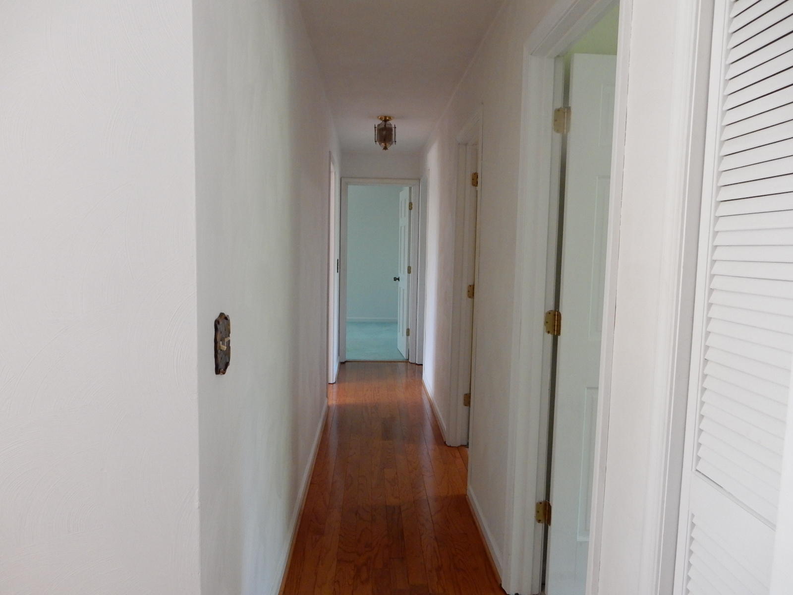 4925 Grape Tree Lane Roanoke, VA 24018 - Photo 14 of 27 a view of a hallway with wooden floor