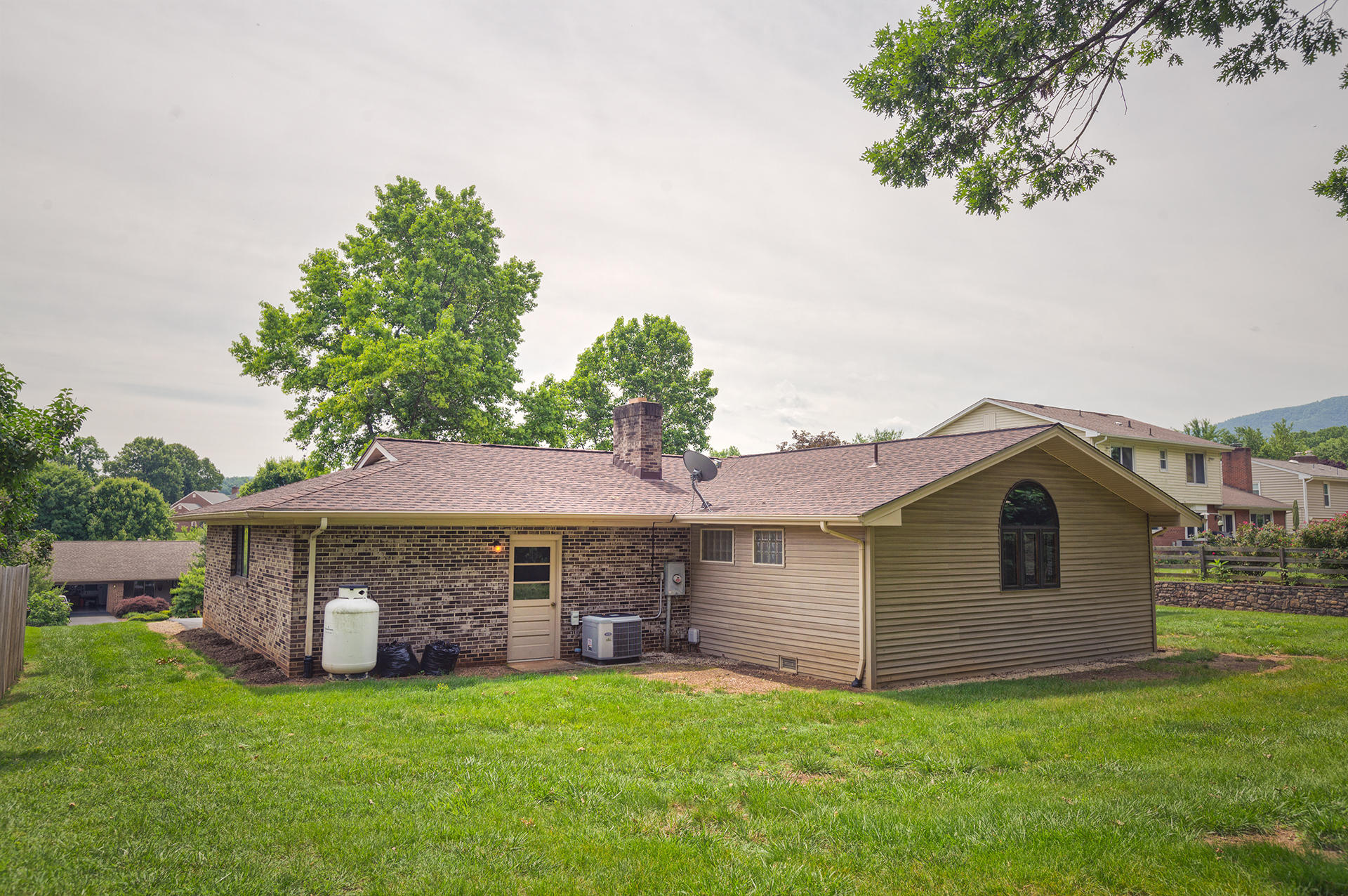 4925 Grape Tree Lane Roanoke, VA 24018 - Photo 25 of 27 a front view of a house with a garden