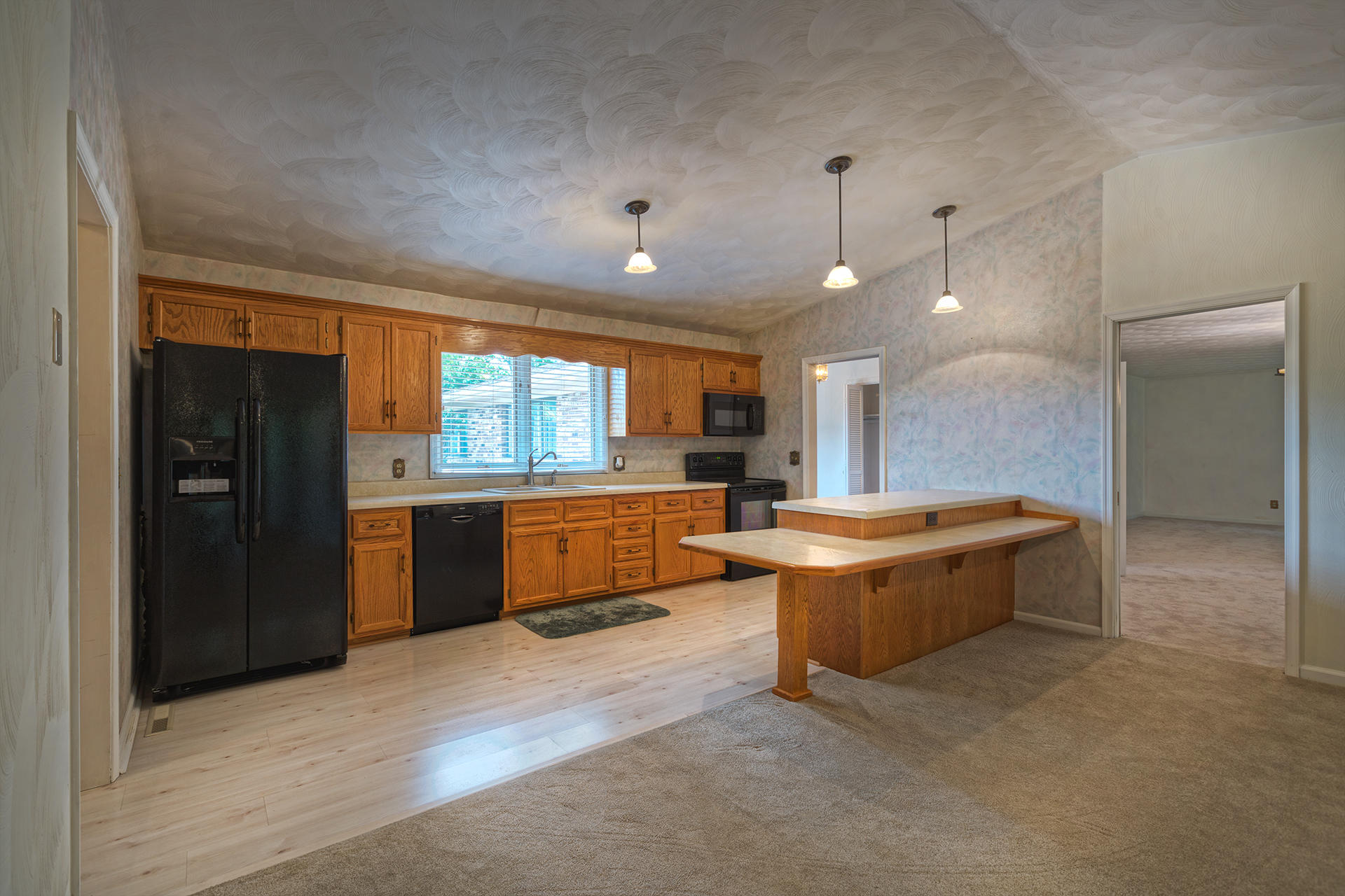 4925 Grape Tree Lane Roanoke, VA 24018 - Photo 6 of 27 a large kitchen with kitchen island a large counter space and stainless steel appliances
